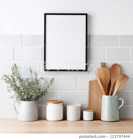 Blank frame for wall art mockup featuring kitchen utensils, herbs, and wooden decor elements in a modern interior design aesthetic 125797444