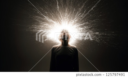 Silhouette of Person With Radiating Sparkling Light and Abstract Creativity Concept 125797491