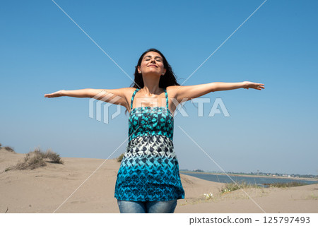 Happy woman portrait with her arms raised up. Happy woman portrait with her arms raised up. 125797493
