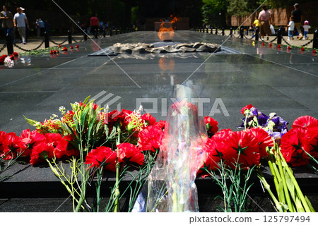 red carnations and bouquets placed at eternal flame memorial 125797494