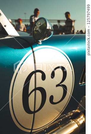 Classic vintage race car number 63 in turquoise and white finish with chrome round mirror Classic vintage race car number 63 in turquoise and white finish with chrome round mirror 125797499