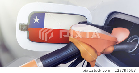 The flag of Chile on the hatch of the gas tank of a car at a gas station in close-up. High or low prices at Chilean gas stations. Chile shortage rise in price of diesel fuel gasoline 125797598