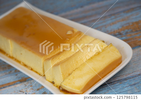 Cream caramel pudding with caramel sauce on a plate, Flan 125798115