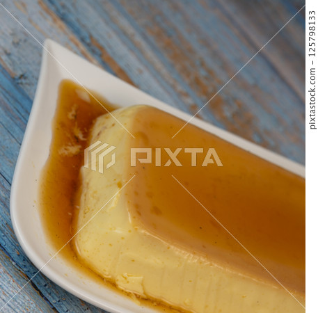 Cream caramel pudding with caramel sauce on a plate, Flan Cream caramel pudding with caramel sauce on a plate, Flan 125798133