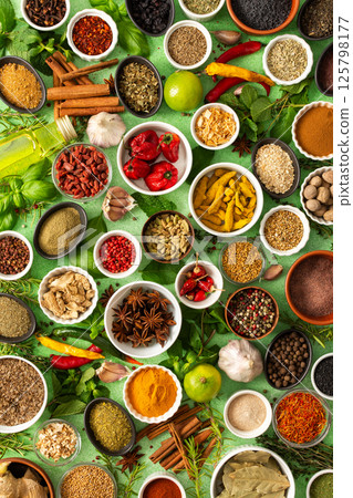 Fresh, fragrant spices and herbs arranged in an array of colors, sitting on a soft green backdrop, bringing flavor and zest to any kitchen Fresh, fragrant spices and herbs arranged in an array of colors, sitting on a soft green backdrop, bringing flavor and zest to any kitchen 125798177