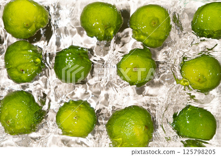 Fresh Whole Limes Floating in Water Top View 125798205