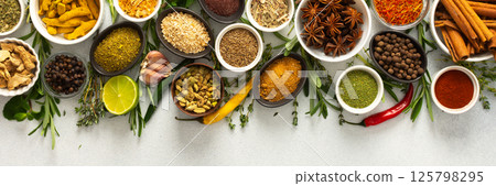 Assorted cooking spices and herbs arranged on a gray surface, featuring natural tones that add depth and aroma to any meal, banner Assorted cooking spices and herbs arranged on a gray surface, featuring natural tones that add depth and aroma to any meal, banner 125798295