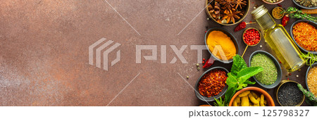 A visually striking arrangement of fresh spices and herbs on a brown surface, highlighting their vivid colors, intricate details, and rich culinary essence, banner 125798327