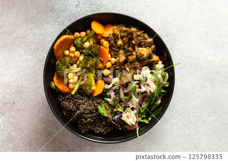 A filling, balanced breakfast with black quinoa, avocado, roast chicken, sweet potatoes, zucchini, broccoli, and a refreshing cabbage and radish salad with chia and sesame seeds 125798335