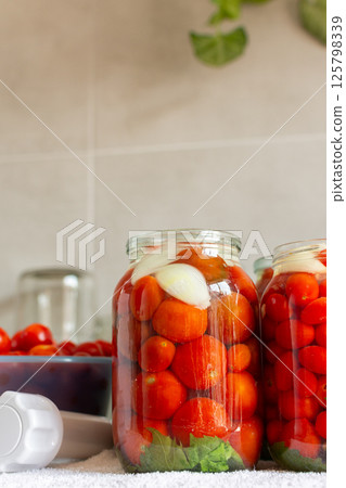Homemade tomato preserves and tomato juice, canned and sealed for winter storage, maintaining flavor and freshness Homemade tomato preserves and tomato juice, canned and sealed for winter storage, maintaining flavor and freshness 125798339