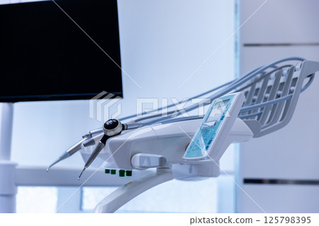 Modern Dental Chair and Equipment: A Glimpse into the State-of-the-Art Dental Clinic Environment Emphasizing Advanced Dental Care and Patient Comfort for Optimal Oral Health Experience. 125798395