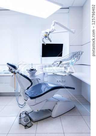 Modern Dental Clinic with Advanced Equipment: A Clean and Bright Dental Chair Ready for Patient Treatment and State-of-the-Art Technology in Dentistry 125798402