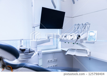 Modern Dental Clinic Interior Featuring State-of-the-Art Equipment and a Comfortable Dental Chair for Patient Treatments in a Bright and Clean Environment 125798404