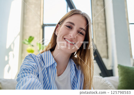 Close-up selfie portrait of teenage female looking at web camera Close-up selfie portrait of teenage female looking at web camera 125798583