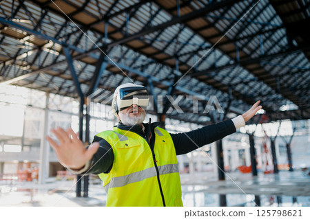 Engineer using virtual reality to inspect building progress. 125798621
