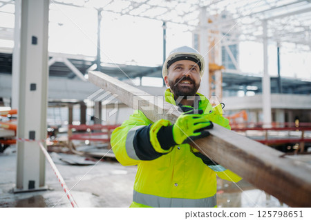 Construction workers at work on modern building site. 125798651