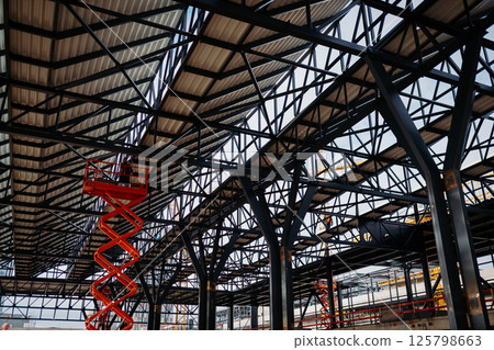 Steel structure of industrial building and scissor lift. 125798663