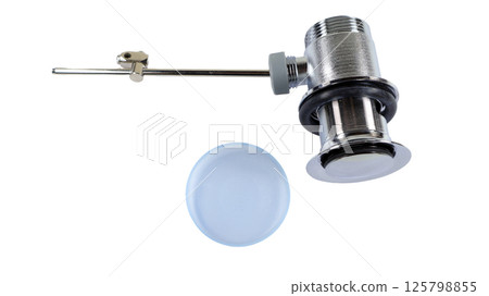 Close-up view of a sink drain shut off valve featuring a metal rod for operation. Ideal for managing water flow in sink plumbing installations at home or in commercial spaces. Close-up view of a sink drain shut off valve featuring a metal rod for operation. Ideal for managing water flow in sink plumbing installations at home or in commercial spaces. 125798855