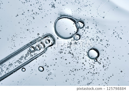 The texture of a serum or cosmetic gel with a pipette. Angle from below. 125798884