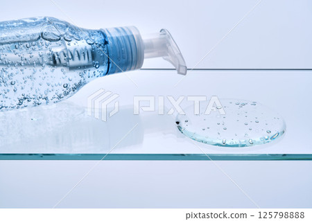 Micellar gel for cleansing the skin from makeup on a glass shelf. 125798888