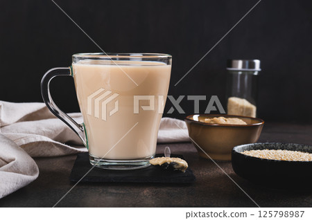 Tahini latte with sesame spread in a cup on the table 125798987
