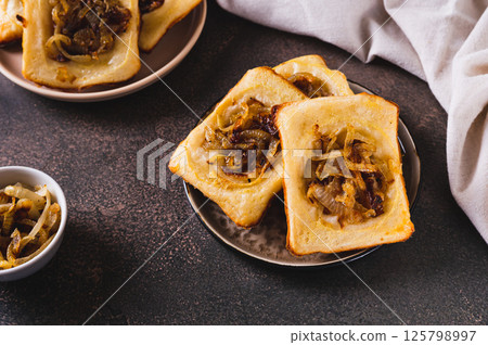 Homemade caramelized onion upside down pies on a plate on a table 125798997