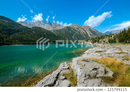 Lake of Ceresole Reale and mountains under blue sky in Italy. Lake of Ceresole Reale and mountains under blue sky in Italy. 125799115