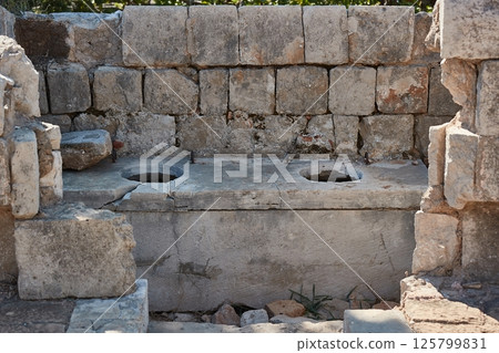 Medieval castle wall toilet, stone holes 125799831