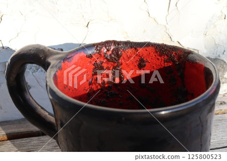 Handmade black ceramic coffee cup. Handmade black ceramic coffee cup. 125800523