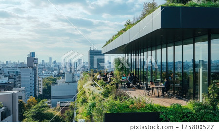 Rooftop terrace with city view; people working & relaxing. 125800527
