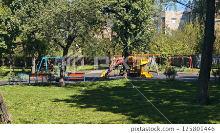 Colorful playground with slides and swings 125801446