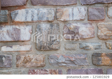 Structural wall of the ancient building of the last century from a stone. Structural wall of the ancient building of the last century from a stone. 125801929