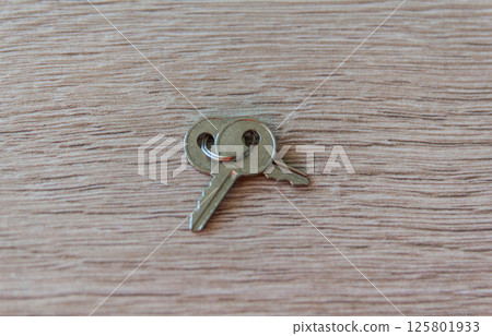 Two old iron keys on the wood table background. Copy space. Flat lay. 125801933