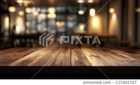 Fashionable wooden table top in a cozy modern cafe with warm lighting and welcoming atmosphere on a blurred background 125802387