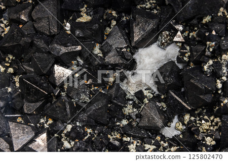 Magnetite is a mineral and one of the main iron ores. Close-up view 125802470