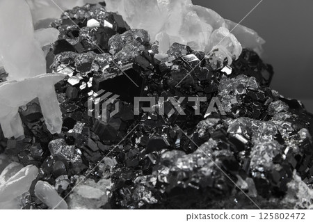 A cluster of flattened calcite crystals. Detailed view of metallic crystals A cluster of flattened calcite crystals. Detailed view of metallic crystals 125802472