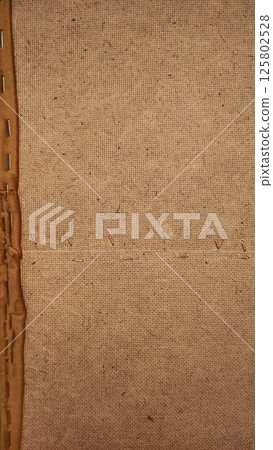 Close up of burlap fabric showing stitching and texture details of sofa 125802528