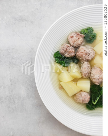Wedding soup with meatballs, potatoes and parsley in white bowl copy space Wedding soup with meatballs, potatoes and parsley in white bowl copy space 125802529