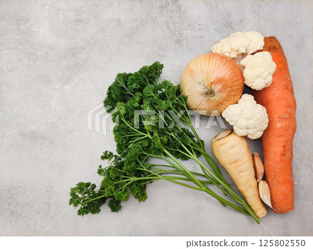 Fresh vegetables lying on gray kitchen countertop ready for cooking copy space preparing vegetables for making soup 125802550