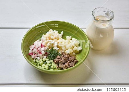 Cold soup ingredients with kefir in green bowl Cold soup ingredients with kefir in green bowl 125803225