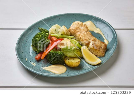 Grilled White Fish with Steamed Vegetables and Lemon 125803229