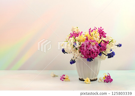 Abstract flower arrangement. Beautiful banner of different varieties of hyacinths and muscari in a vase, template for design and screen. Spring card, business card for product display, 125803339