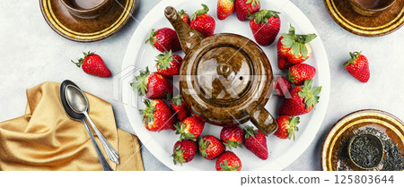 Strawberry tea with fresh strawberries. 125803644