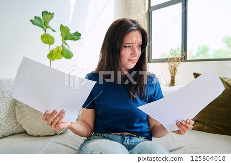 Webcam view young serious woman with business papers having video 125804018