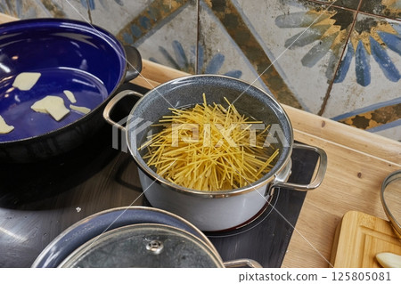 Cooking dinner with pasta at home Cooking dinner with pasta at home 125805081