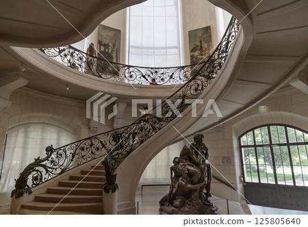 View of Ornamental iron staircase handrail and Bronze sculpture "Ugolin and his sons" decoration inside at the Petit Palais. View of Ornamental iron staircase handrail and Bronze sculpture "Ugolin and his sons" decoration inside at the Petit Palais. 125805640
