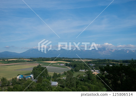 Summer green upland field and mountain range Tokachidake mountain range 125806514