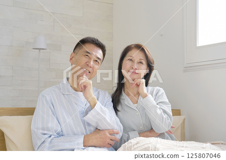 A couple in pajamas imagining A couple in pajamas imagining 125807046