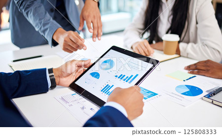 Business meeting with hands pointing at tablet screen displaying corporate data, charts, and graphs for revenue analysis and budget performance, creating collaborative atmosphere Business meeting with hands pointing at tablet screen displaying corporate data, charts, and graphs for revenue analysis and budget performance, creating collaborative atmosphere 125808333