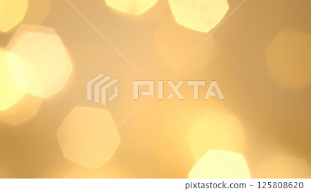 Warm light background with soft golden tones creates soothing atmosphere, featuring hexagon bokeh highlights that radiate gentle glow, perfect for adding elegance to any design Warm light background with soft golden tones creates soothing atmosphere, featuring hexagon bokeh highlights that radiate gentle glow, perfect for adding elegance to any design 125808620